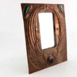 An Arts and Crafts copper and cabochon set mirror