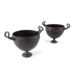 A pair of cast bronze twin handled vases