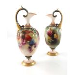James Hadley for Royal Worcester, a pair of rose and berry painted ewers