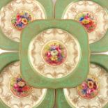 E Phillips for Royal Worcester, a set of five flower painted dessert plates within gilt borders, 192