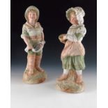 A pair of Gebruder Heubach bisque figures of fisher boy and cockle picker