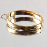 A 9ct gold hinged bangle