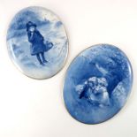 A pair of Doulton Burslem blue children plaques