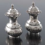 A pair of Edwardian silver salt or pepper pots, George Nathan and Ridley Hayes, Chester 1907