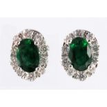 A pair of emerald and diamond cluster earrings