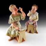 A pair of Gebruder Heubach bisque figures of children