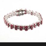 An 18ct gold ruby and diamond line bracelet