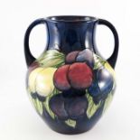 William Moorcroft, A wisteria on blue twin handled vase