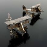 A pair of novelty white metal aeroplanes