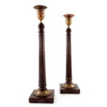 A pair of George III mahogany and Old Sheffield Plate mounted candlesticks