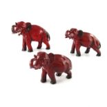 Charles Noke for Royal Doulton, a graduated set of three Flambe Elephant figures