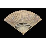 λ Two 18th century fans, an early 18th century ivory fan with slender monture, the upper guards carv