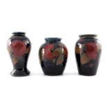 William Moorcroft, three small Pomegranate vases