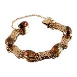 An Arts & Crafts style 9ct gold moss agate bracelet