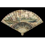 An 18th century fan with ornate carving, in particular when views closed, from the side, the Buddha