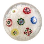 Baccarat, spaced millefiori paperweight set with seven individual canes, on a muslin ground, circa 1