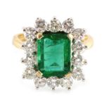 An 18ct gold emerald and diamond cluster ring