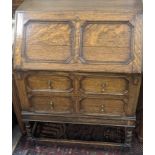 A William and Mary style oak bureau, compartmentalised interior over two long drawers, H.75cm W.