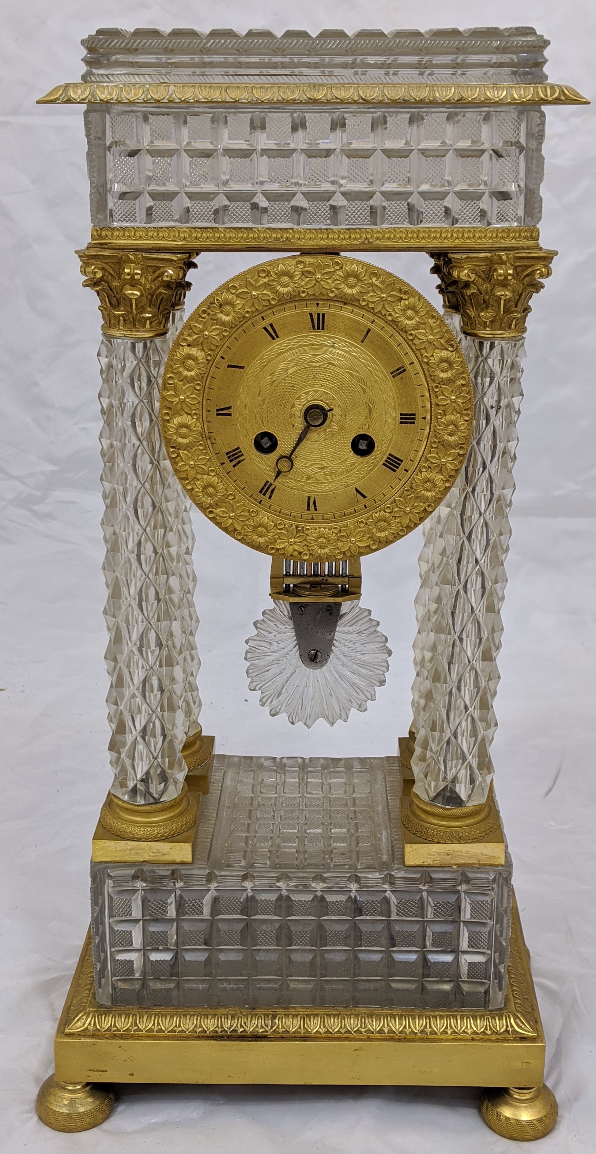 A French Empire Portico clock,four crystal column supports mounted with ormolu Corinthians with