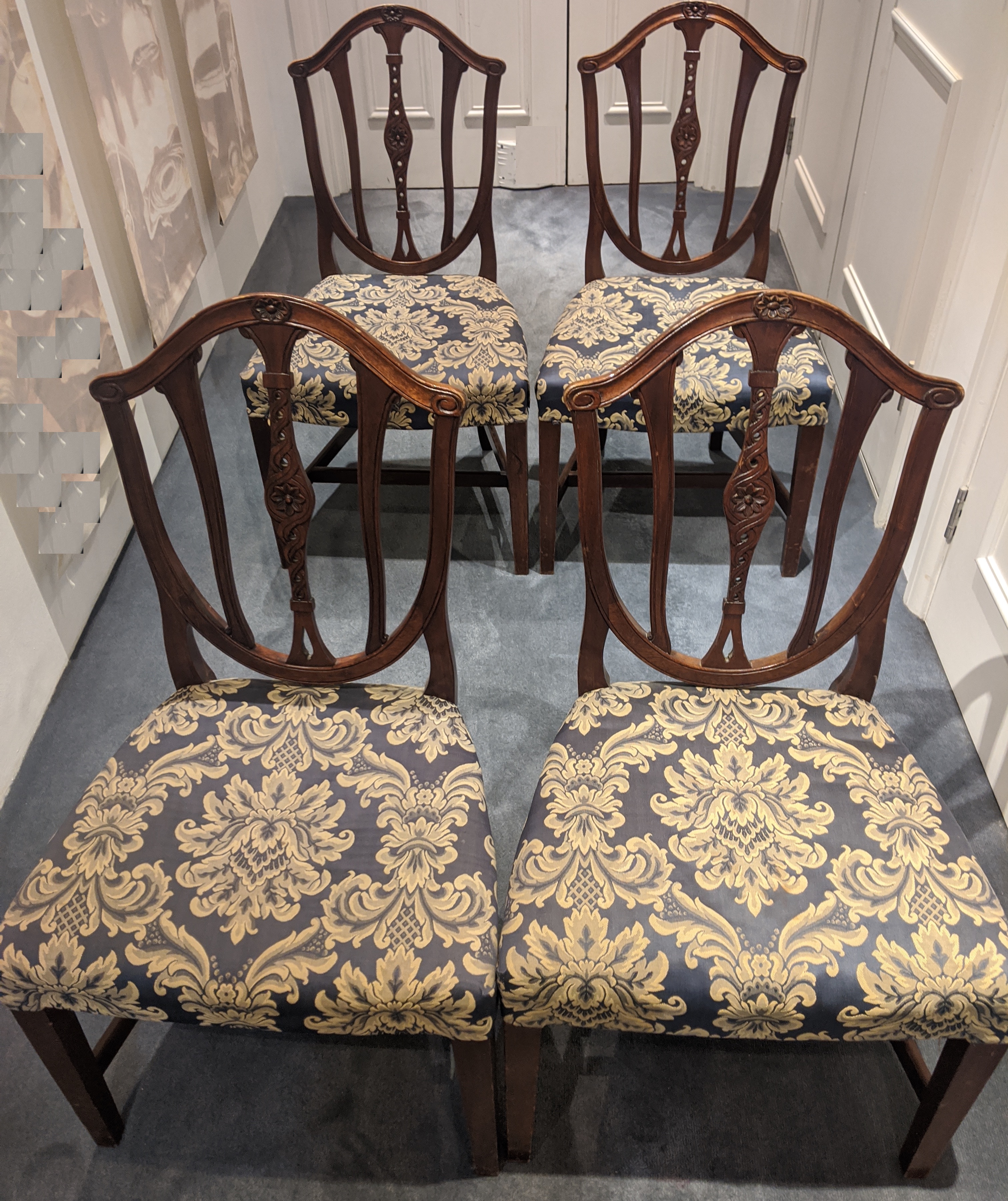 Four mahogany framed dining chairs with floral upholstery