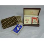 A collection of playing cards to include a leather case Dunhill set and a Louis Vuitton set,