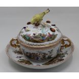 A German porcelain twin handled cup with lid and saucer, bird finial (repair to tail), bearing