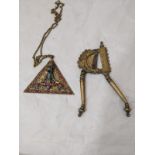 A pair of bronze cutters, together with an Indian, possibly Tibetan, filigree pendant, depicting the