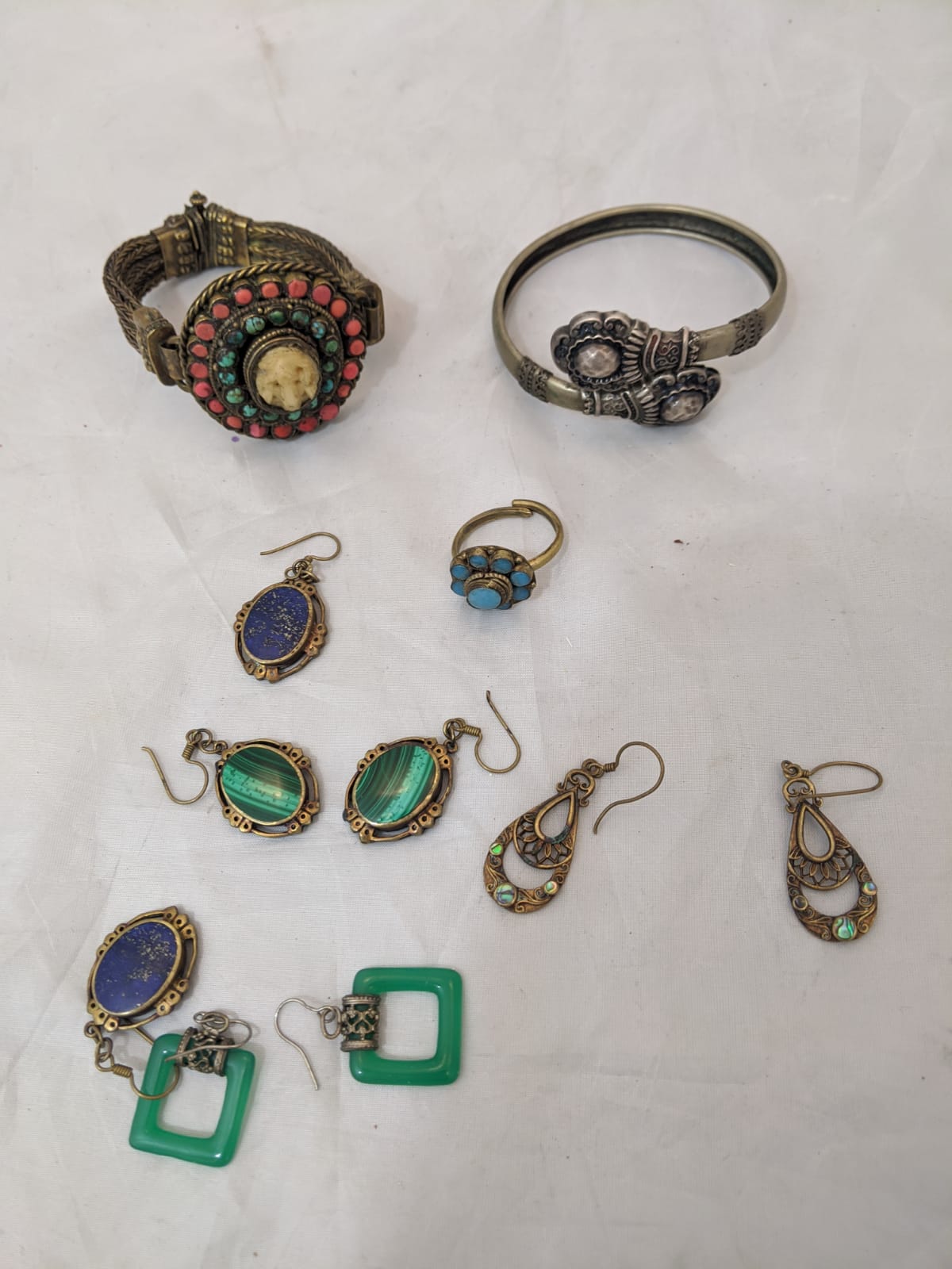 A collection of Middle Eastern Jewellery, to include bangles, earrings, and rings, mounted with