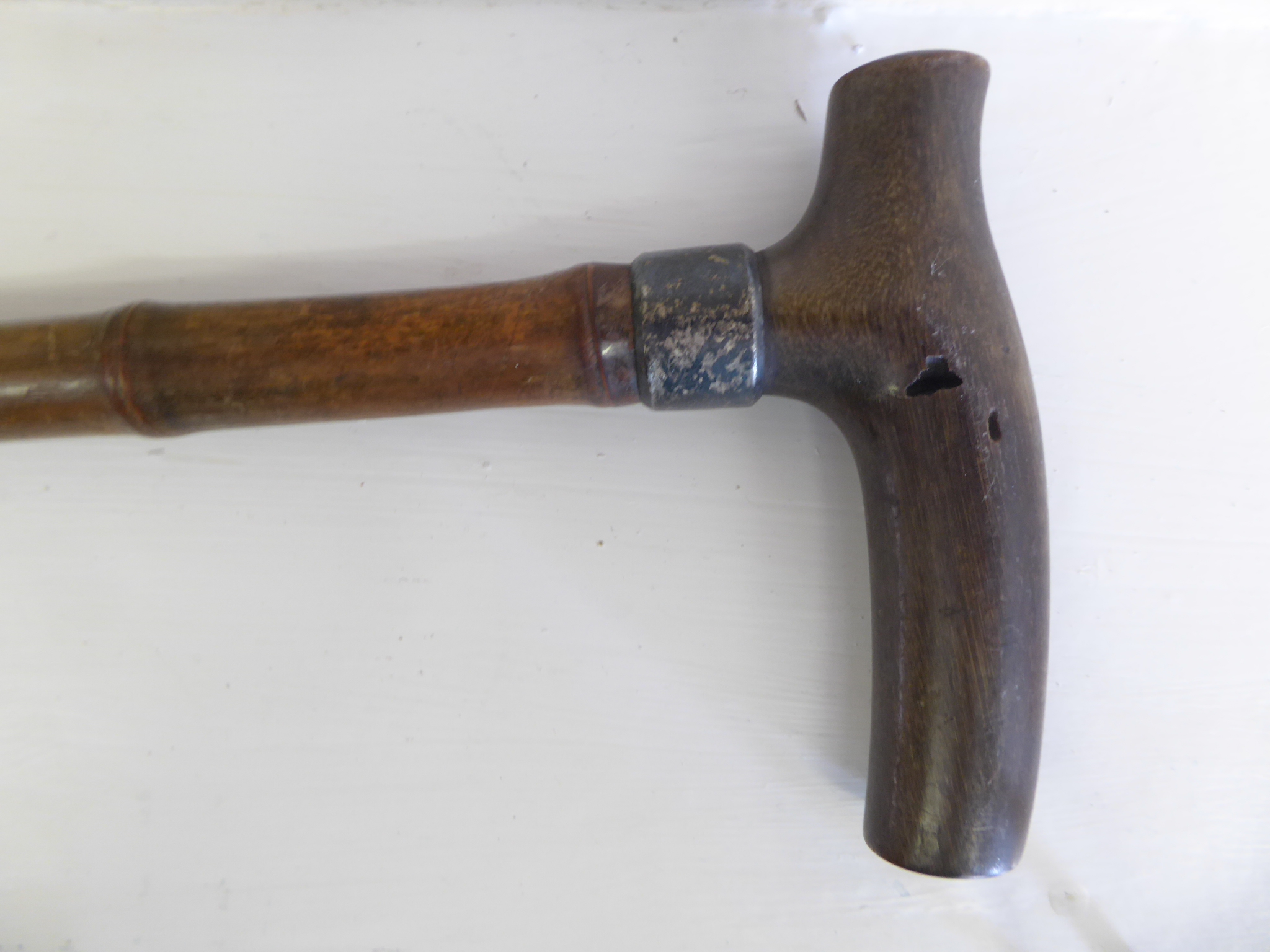 A 19th century rhino horn handled walking cane with silver collar   Note this items is subject to