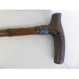A 19th century rhino horn handled walking cane with silver collar   Note this items is subject to