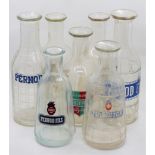 A collection of seven French glass carafes to include Pernod, Noilley Pray Vermouth and Suze