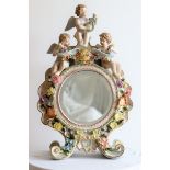 A large Sitzendorf German porcelain clock case converted to mirror with cherubs, H.57cm