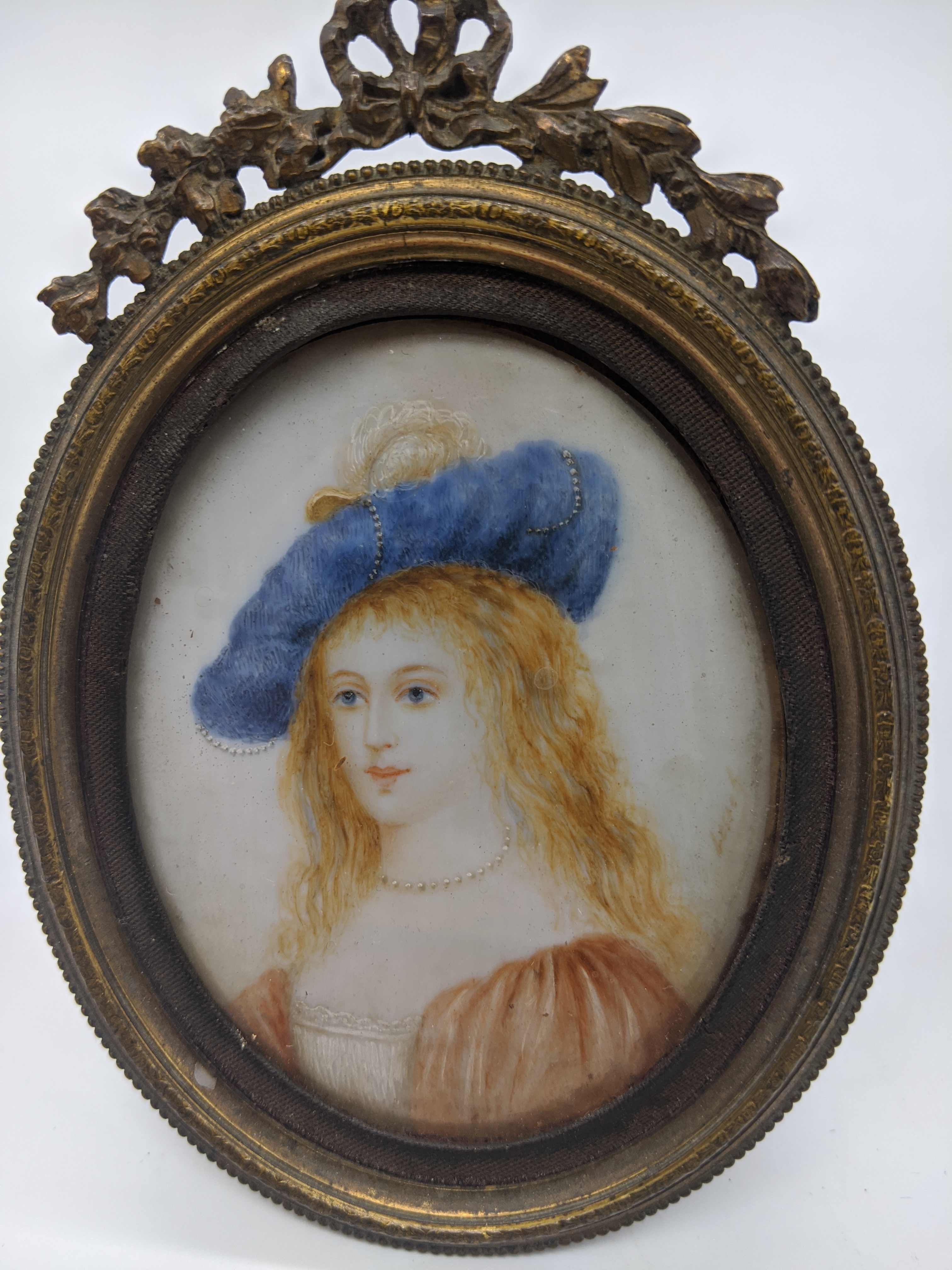 A 19th century miniature portrait of a maiden, oil, indistinctly signed, H.7.5cm