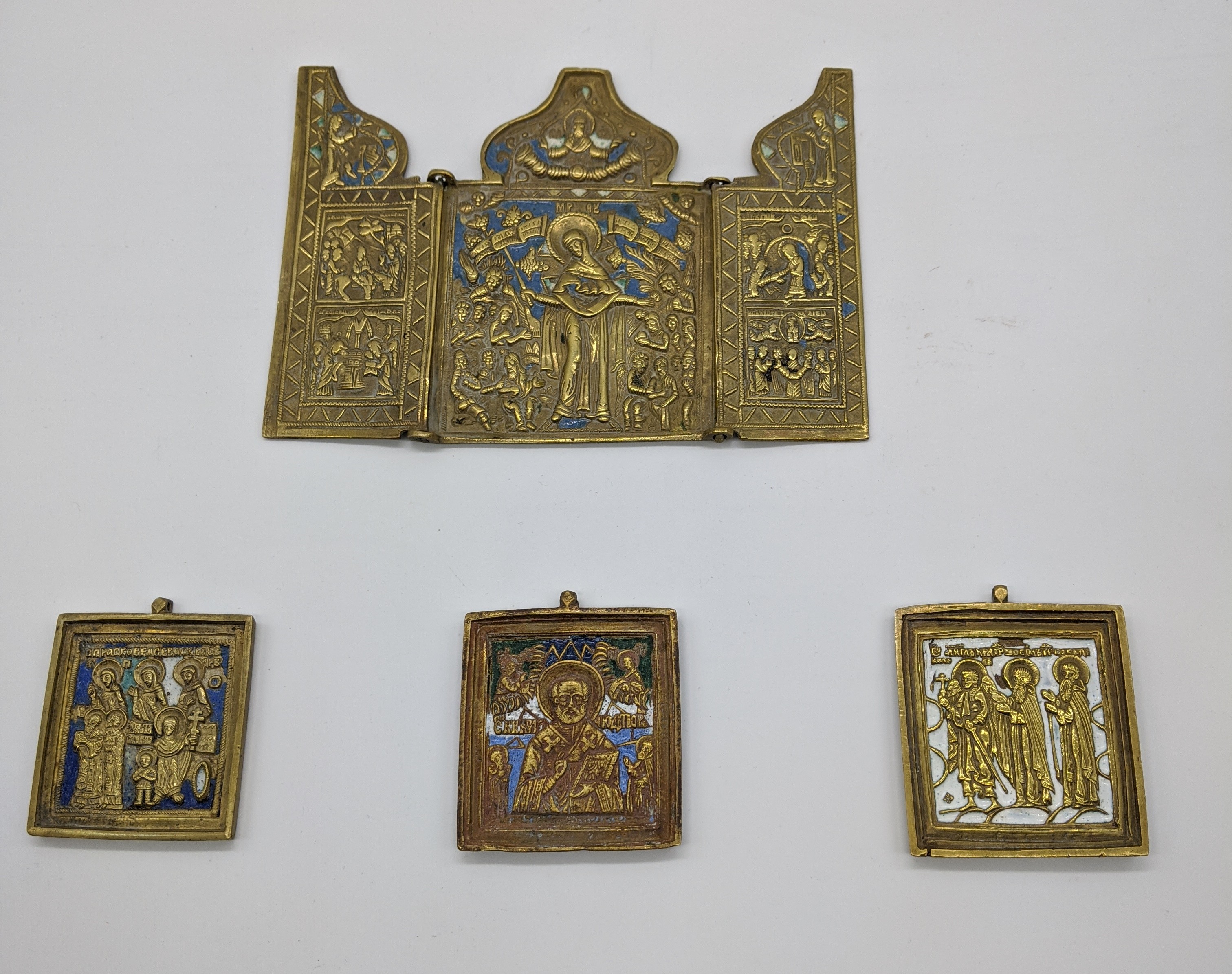 Four bronze and enamel Russian Icons to include one triptych of the life of the Theotokos H.11cm