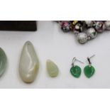 Two mutton fat jade pendants, green jade earrings, a jadeite circular pendant, cloisonne enamel bead