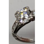 An iridium platinum diamond ring, flanked with six smaller diamonds, size O
