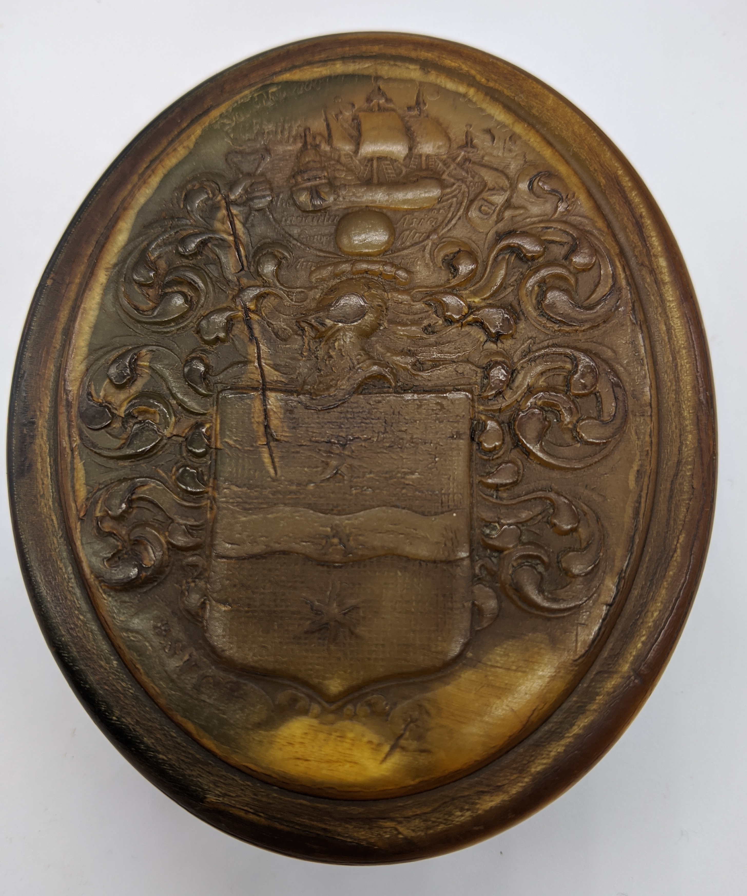 Attributed to John Obrisset, a Queen Anne oval shaped horn snuff box, impressed with the arms of Sir