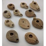 A collection of ancient terracotta oil lamps, examples include Byzantine, Hellenistic, Islamic (11),