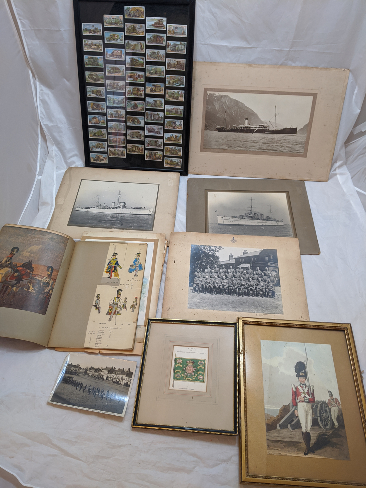 A collection of military interest items to include a framed collection of Wills Cigarette cards of