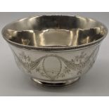 A heavy Continental silver bowl, decorated with stylised foliage and vacant cartouche, bead banding,