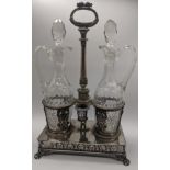 A large Continental silver oil and vinegar set, raised on paw feet, pierced scrolling design