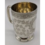 A Victorian silver mug, scrolling embossing, vacant cartouche, 147g, H.10cm