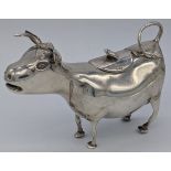 A silver Cow creamer by Samuel Boyce Landeck, the hinged lid with a handle in the form of a bee,