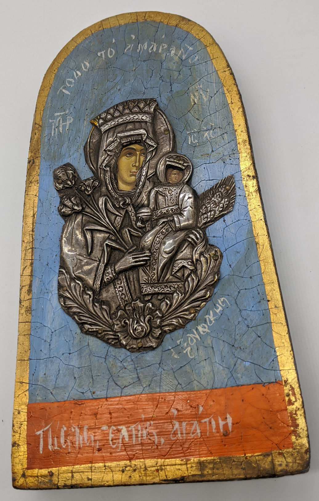 A Russian or Greek icon of Mary and Baby Jesus mounted with white metal, H.22.5cm W.12cm