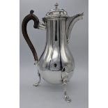 An 18th century Continental silver water jug on three feet, marks to base, 640g, H.26.5cm,