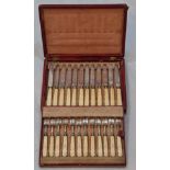 Twelve sets of Georgian silver knives and forks with ivory handled within original red leather case,