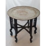 A Chinese folding tables with circular copper top, carved and pierced legs