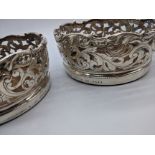 A pair of John Samuel Hunt silver coasters, the wooden turned bases with applied silver boss with