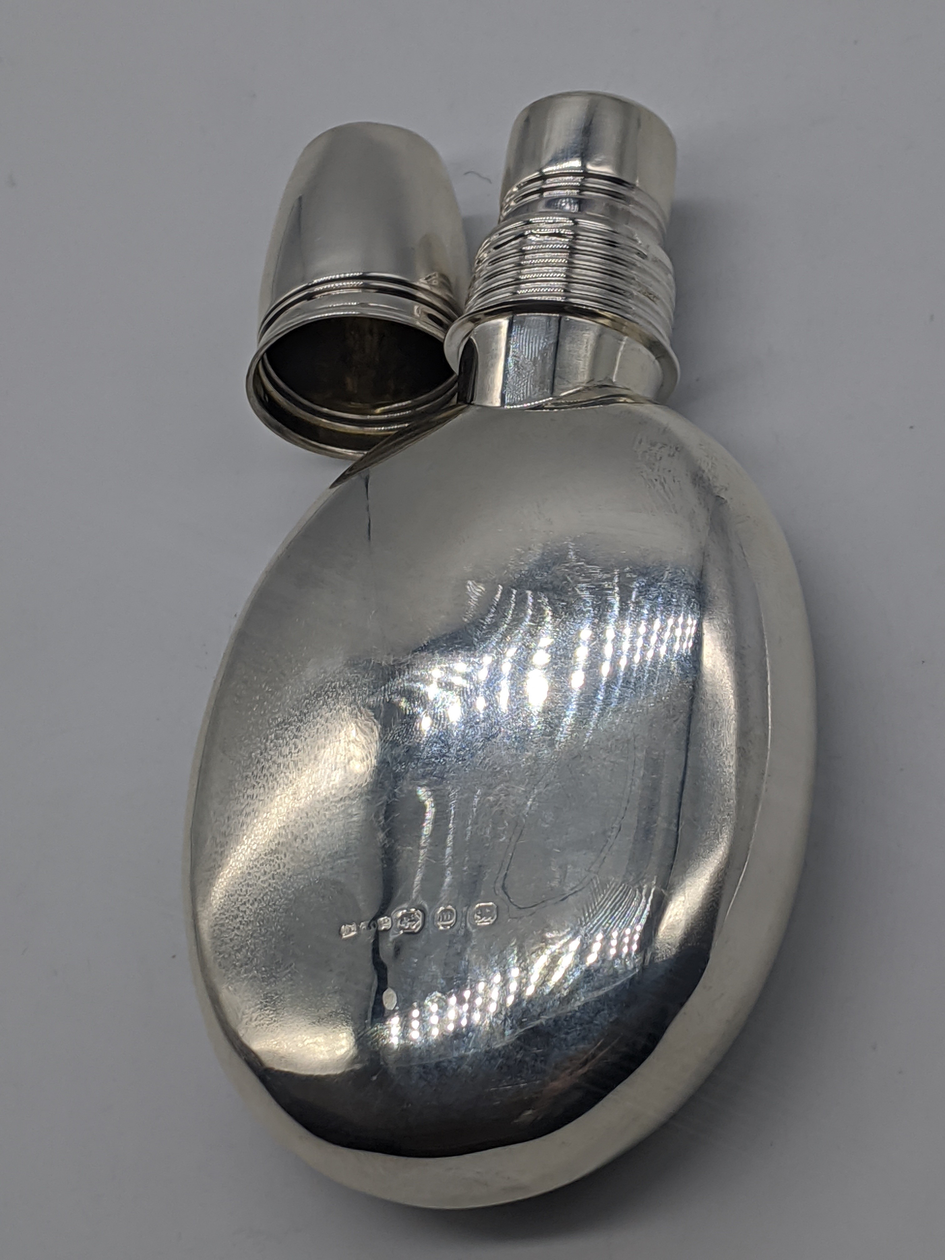 A silver hip flask with shot cup as lid, hallmarked Birmingham, 1896, maker George Edwin Walton,