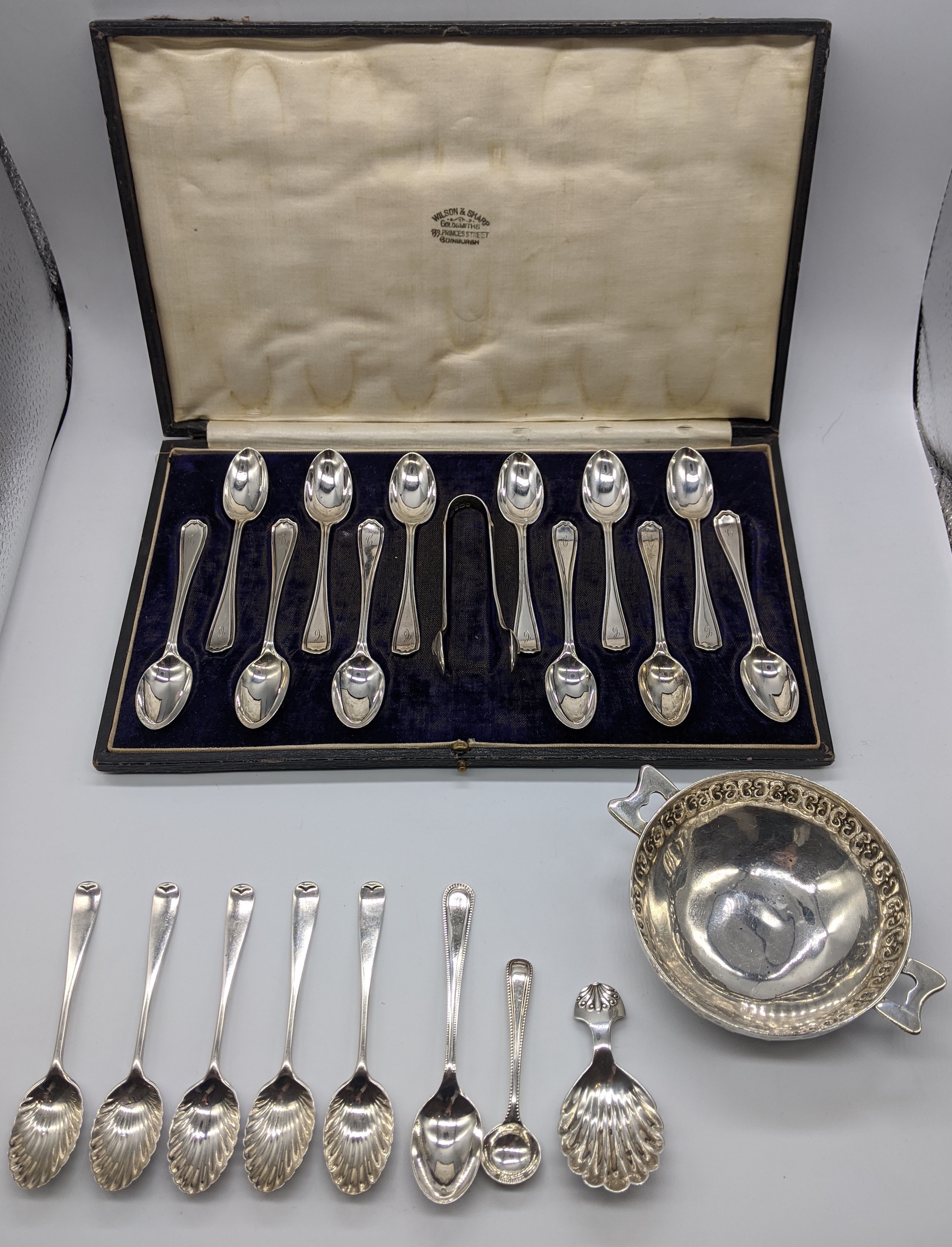 A collection of silver to include a cased set of 12 spoons (tongs not original), 6 teaspoons, a